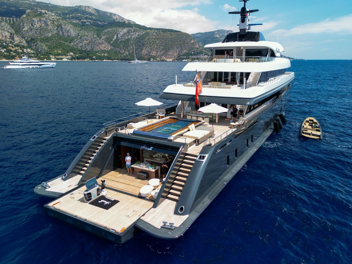 Aerial view of M/Y Loon at anchor on the Riviera with her beach club open and the golf simulator on the swim platform