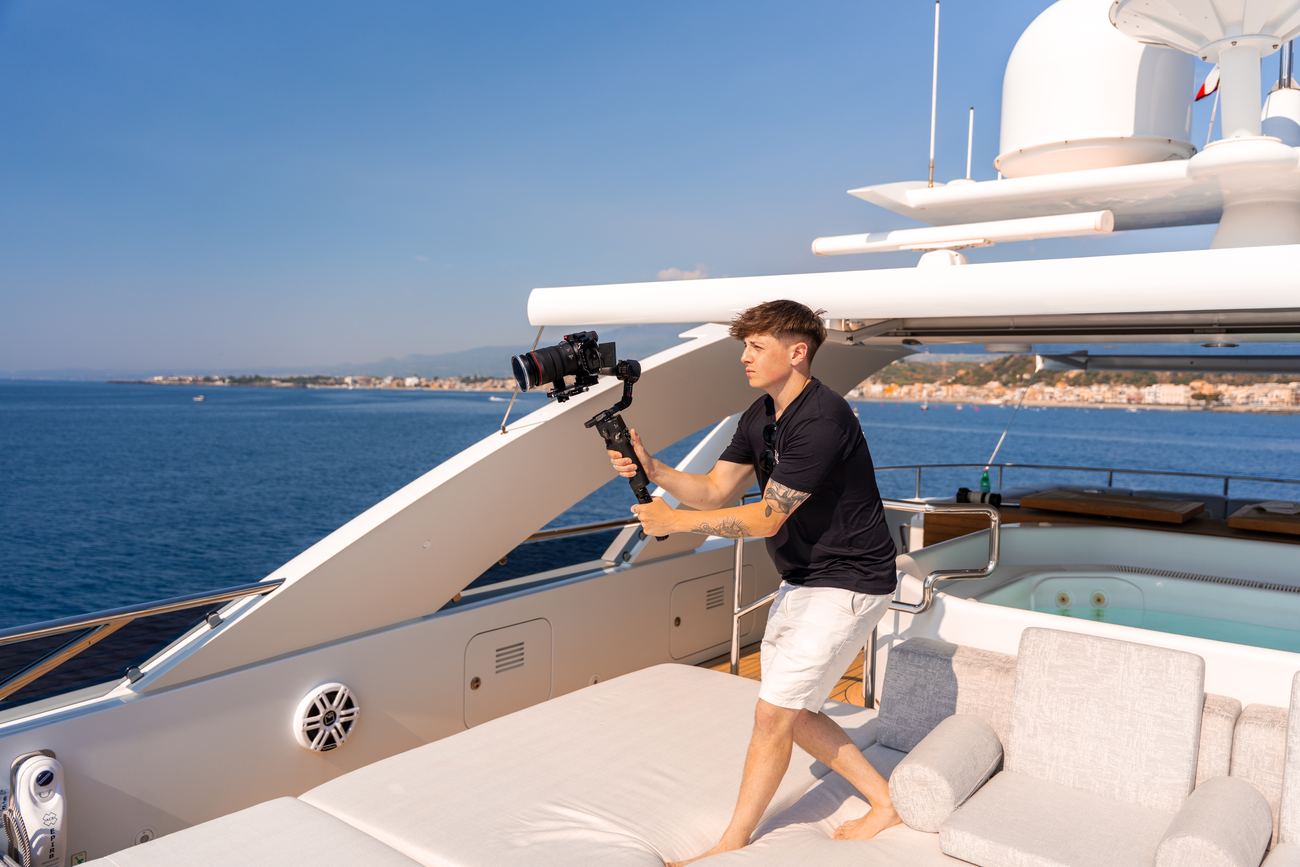 Callum Johns filming on the sundeck of a superyacht in the Mediterranean