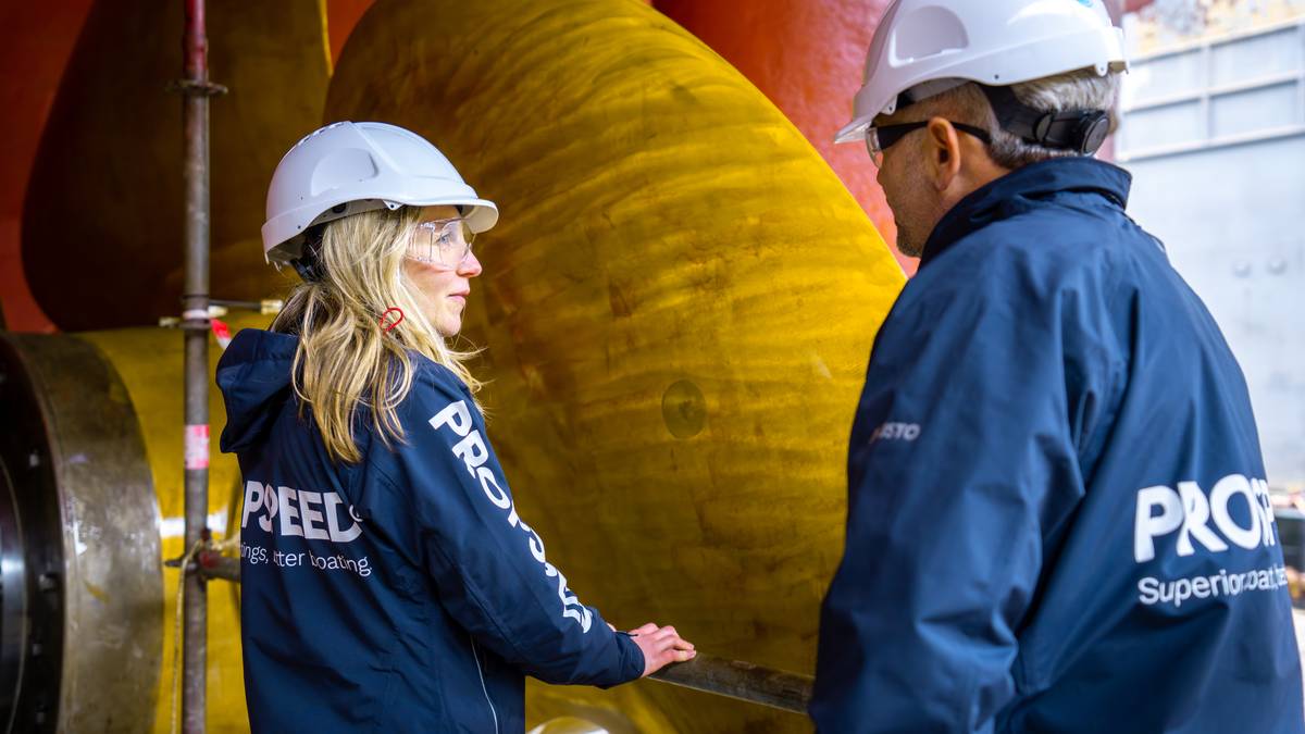 Two Propspeed engineers inspecting a superyacht propeller in a shipyard
