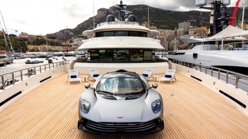 An Aston Martin on the foredeck of a superyacht in Monaco harbour